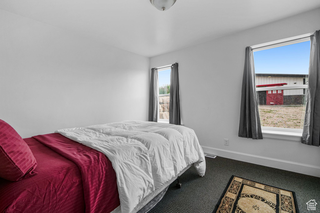 Bedroom with carpet flooring and baseboards
