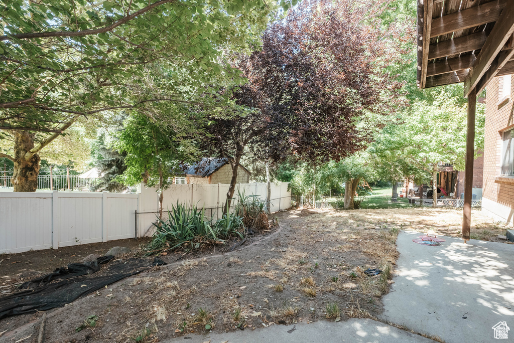 View of yard featuring fence