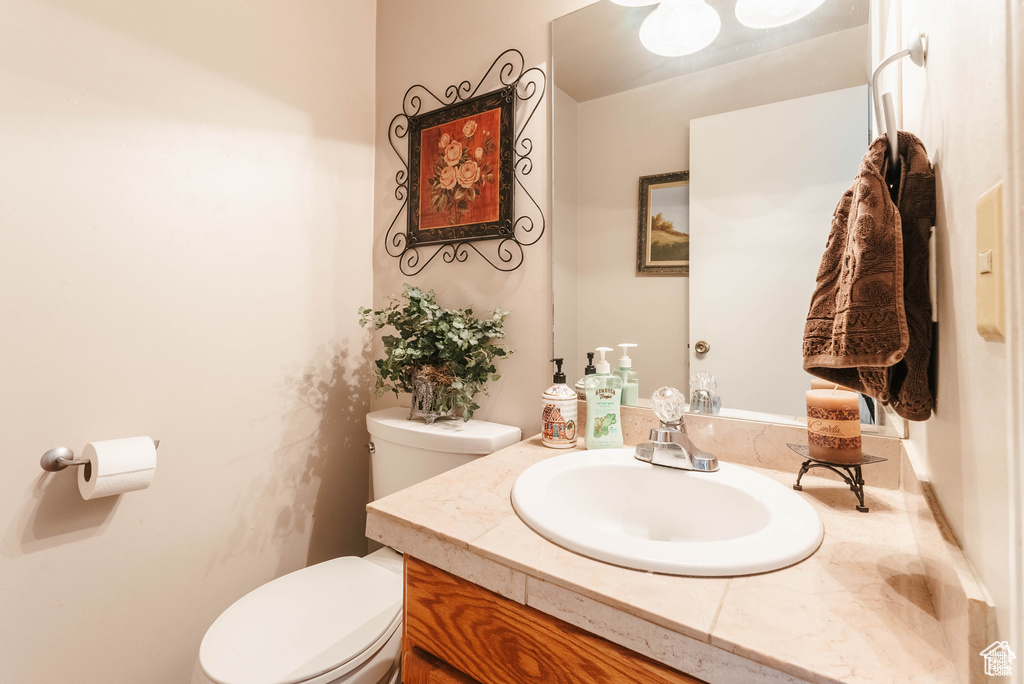 Half bathroom with toilet and vanity