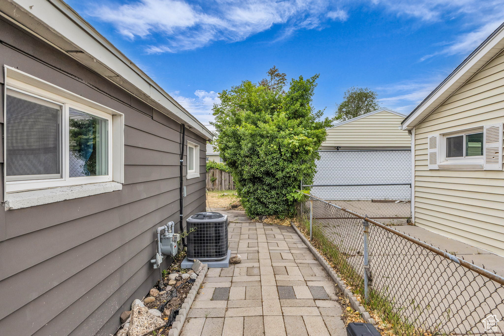 View of patio featuring central AC unit and a fenced backyard