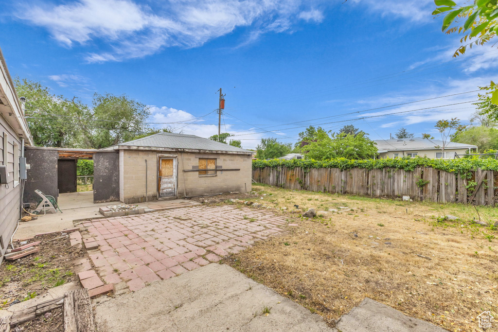 View of yard with a patio and fence