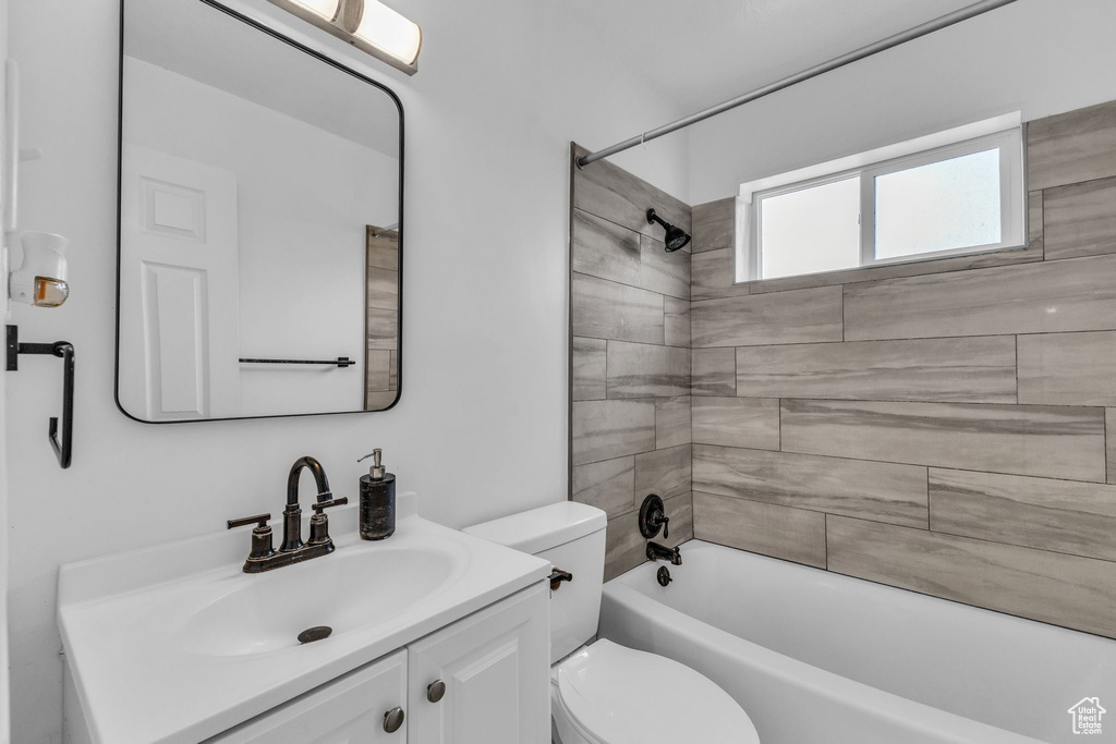 Full bath with toilet, vanity, and bathtub / shower combination