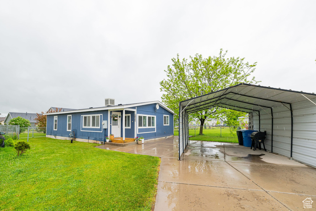 View of front of property with a detached carport and concrete driveway