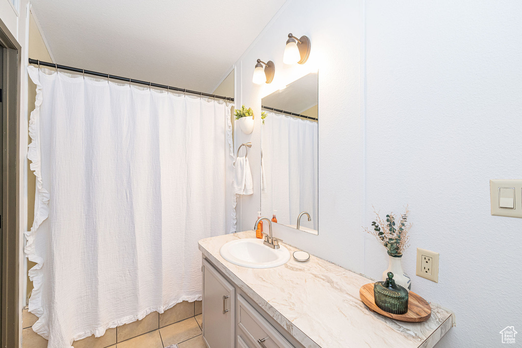 Full bathroom featuring vanity and tile patterned floors