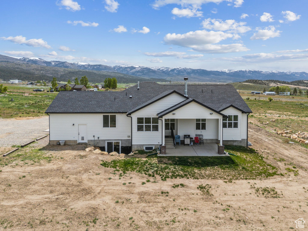 Back of house featuring a patio and a mountain view