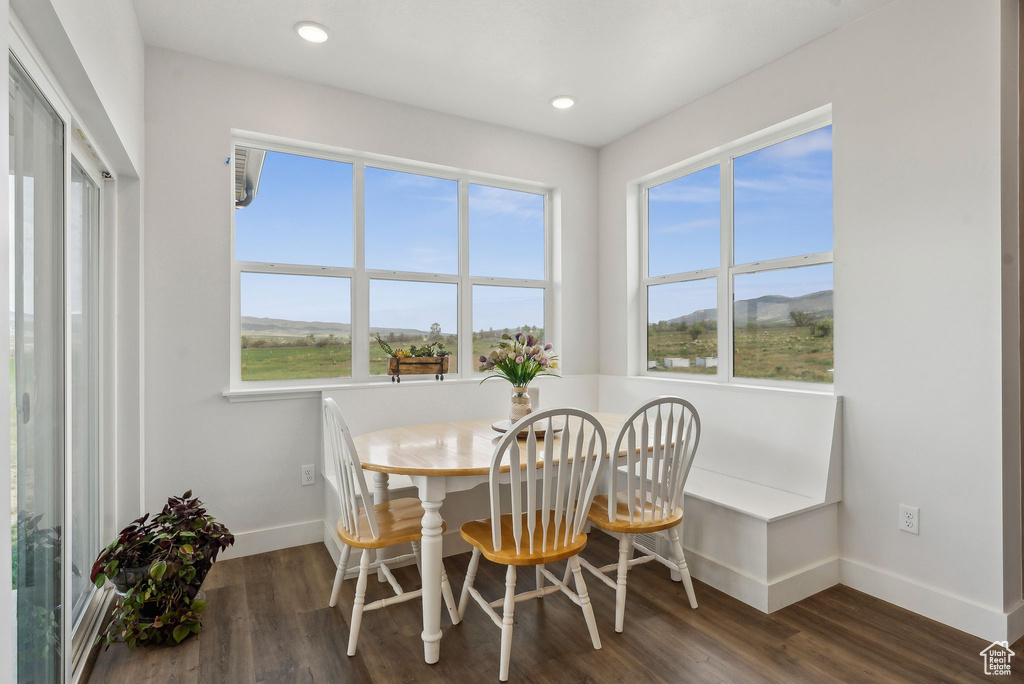 Dining area with baseboards, wood finished floors, and recessed lighting