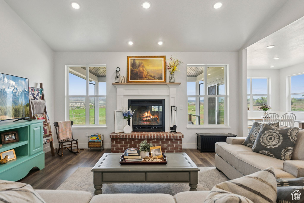 Living room featuring healthy amount of natural light, recessed lighting, baseboards, wood finished floors, and a fireplace