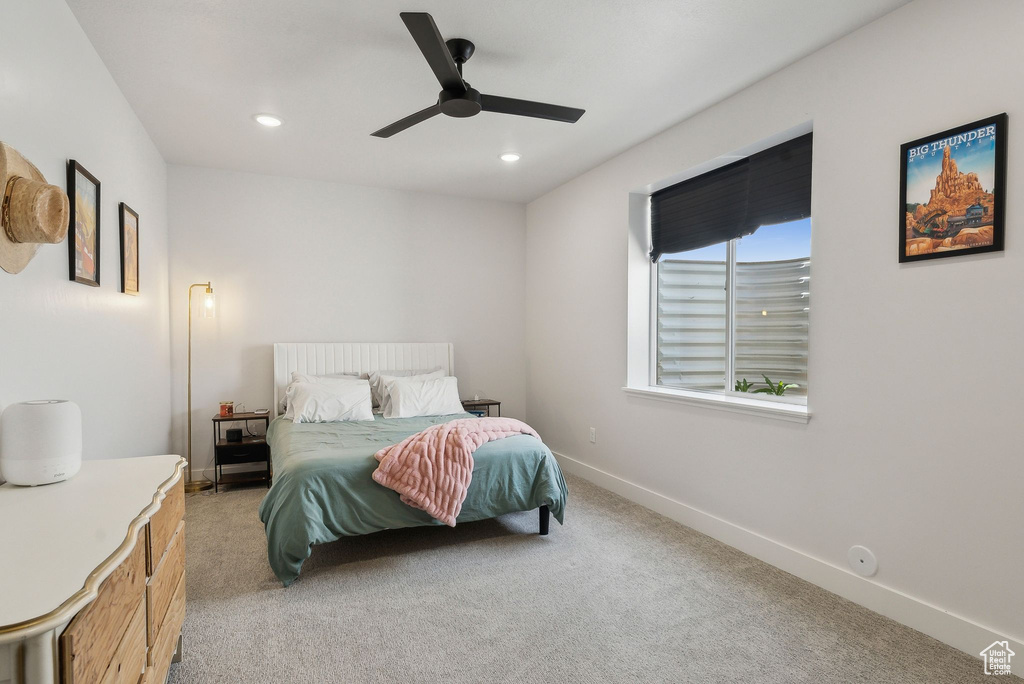 Bedroom featuring light colored carpet, baseboards, recessed lighting, and a ceiling fan