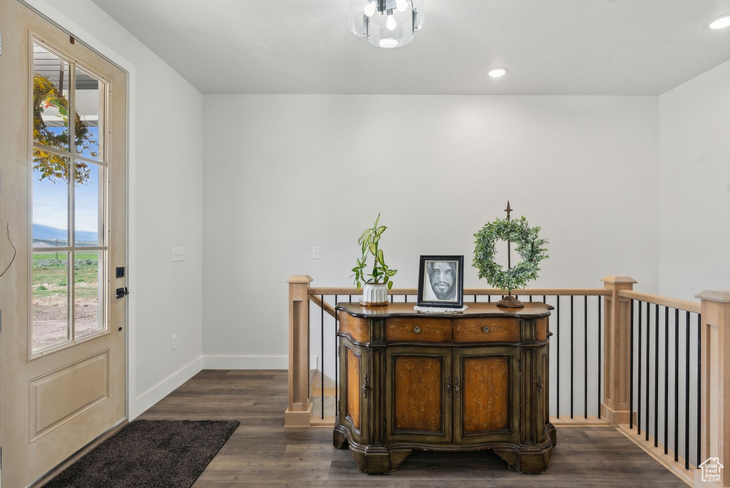 Entryway with dark wood-style floors, baseboards, and recessed lighting