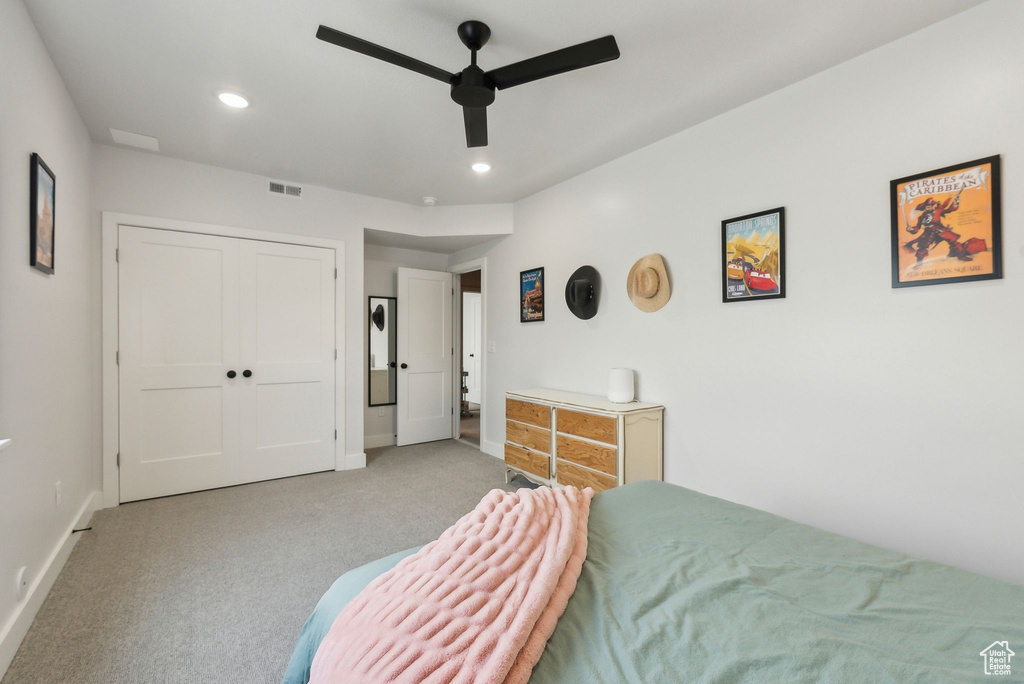 Carpeted bedroom featuring baseboards, recessed lighting, a ceiling fan, and a closet