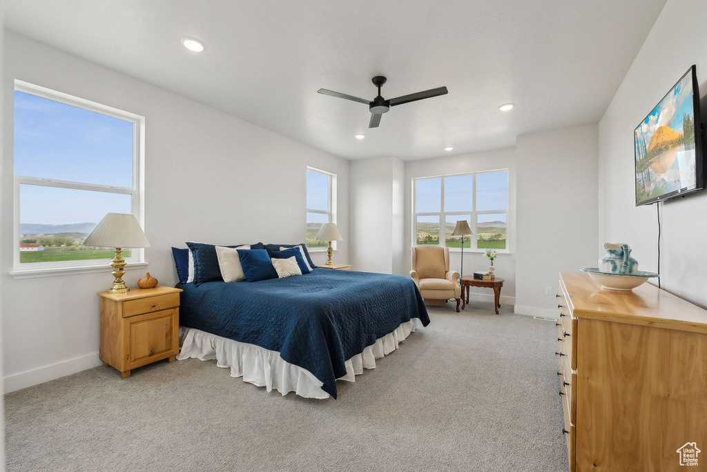 Bedroom featuring light carpet, baseboards, recessed lighting, and a ceiling fan