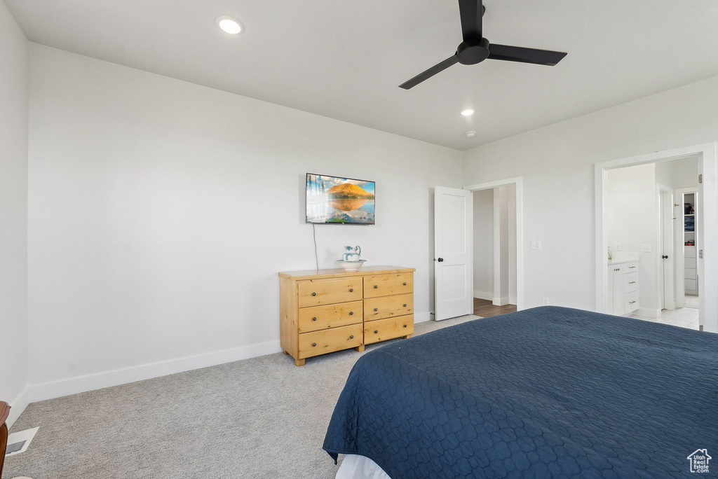 Bedroom with baseboards, recessed lighting, light colored carpet, connected bathroom, and ceiling fan