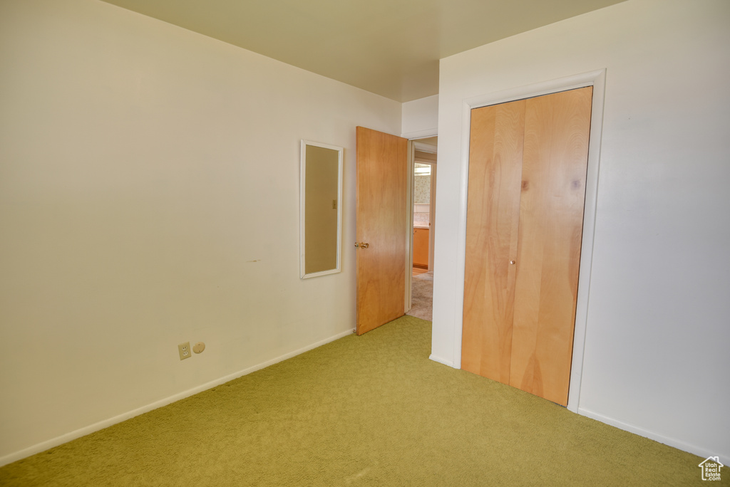 Unfurnished bedroom featuring carpet floors, a closet, and baseboards