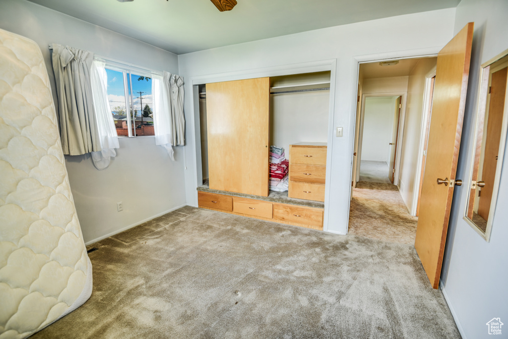 Unfurnished bedroom featuring carpet flooring and a closet