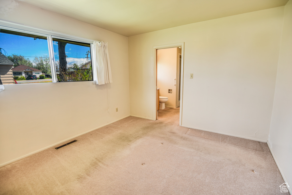 Unfurnished room with light colored carpet and baseboards