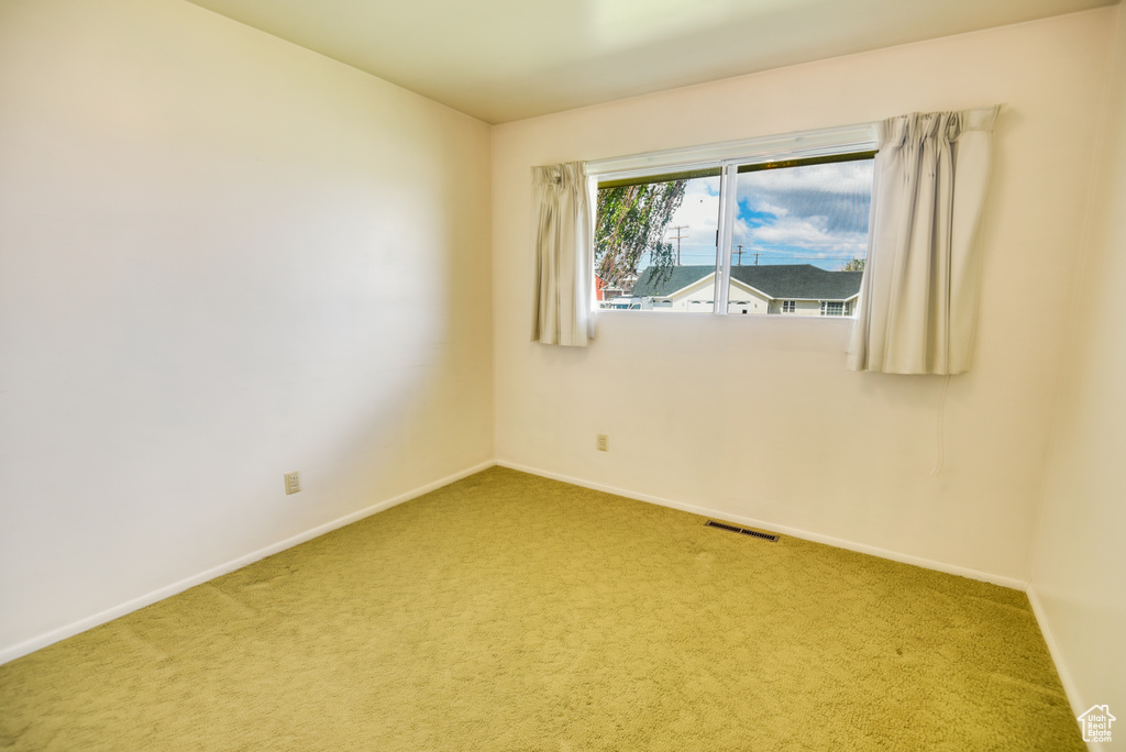 Empty room with carpet floors and baseboards