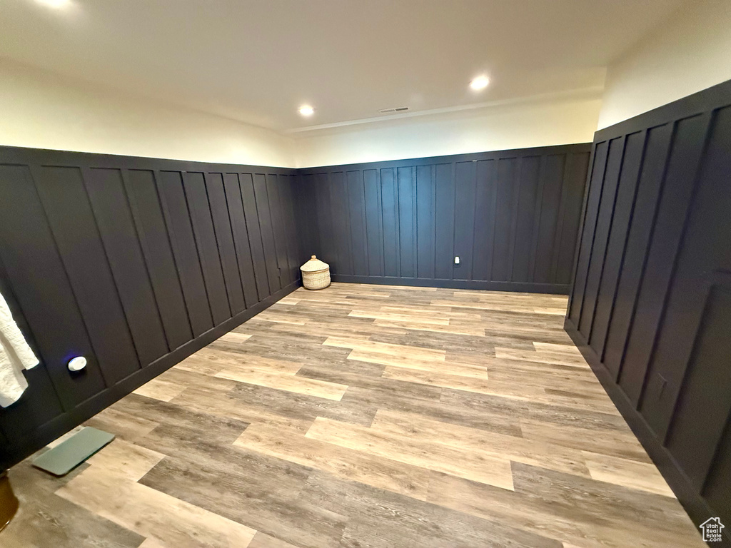 Unfurnished room featuring wainscoting and light wood-style flooring