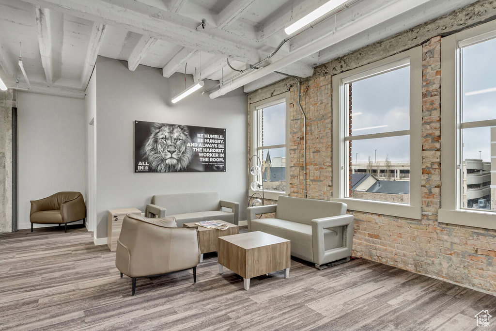 Lobby featuring brick wall and beam ceiling