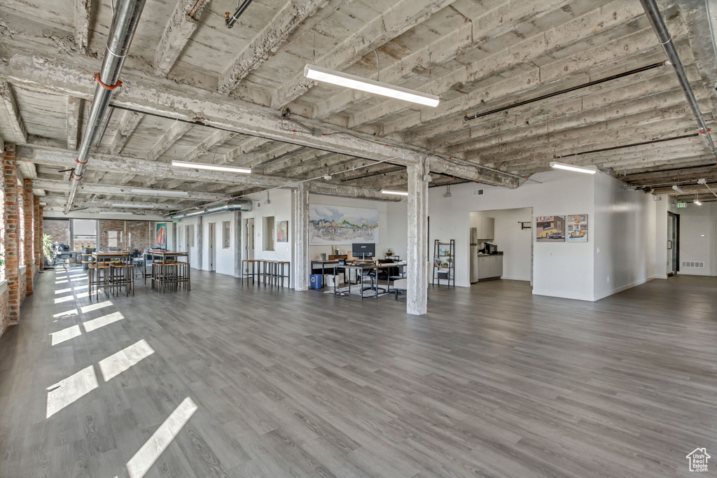 Miscellaneous room with an office area, wood finished floors, and baseboards