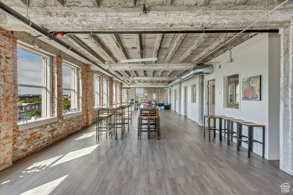 Dining area featuring wood finished floors and brick wall