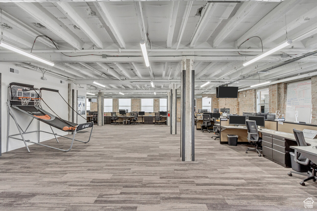 Below grade area featuring a desk and wood finished floors