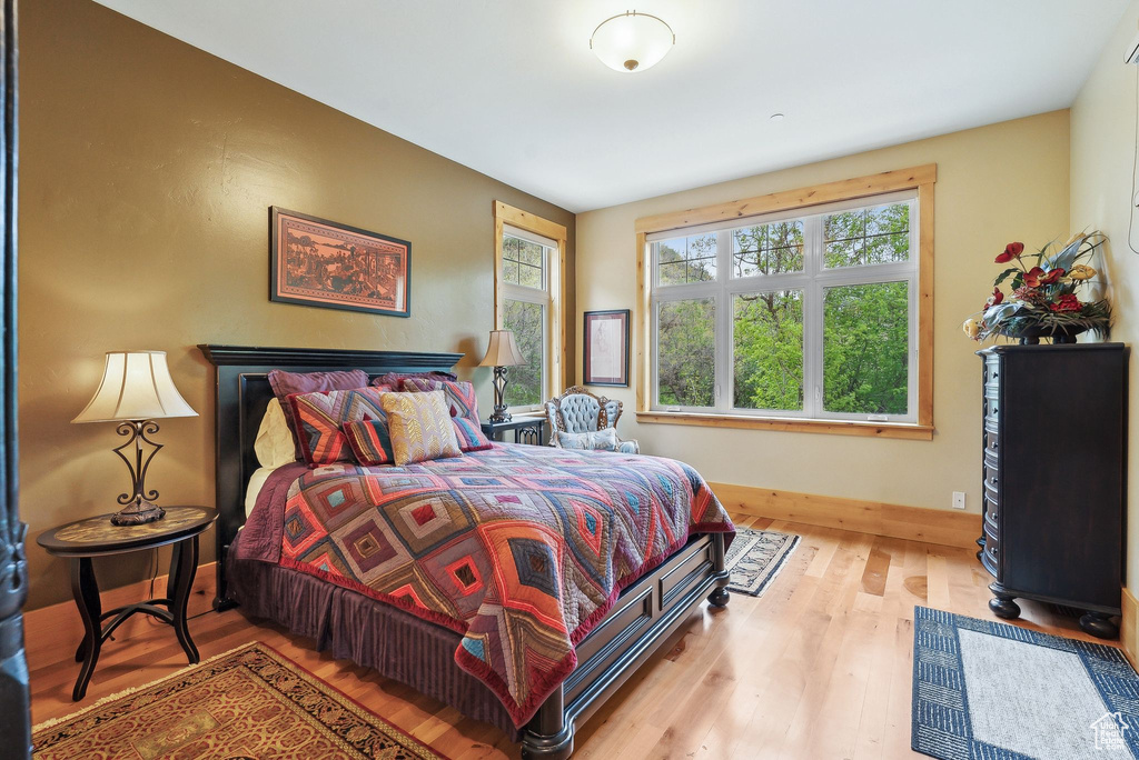 Bedroom featuring wood finished floors and baseboards