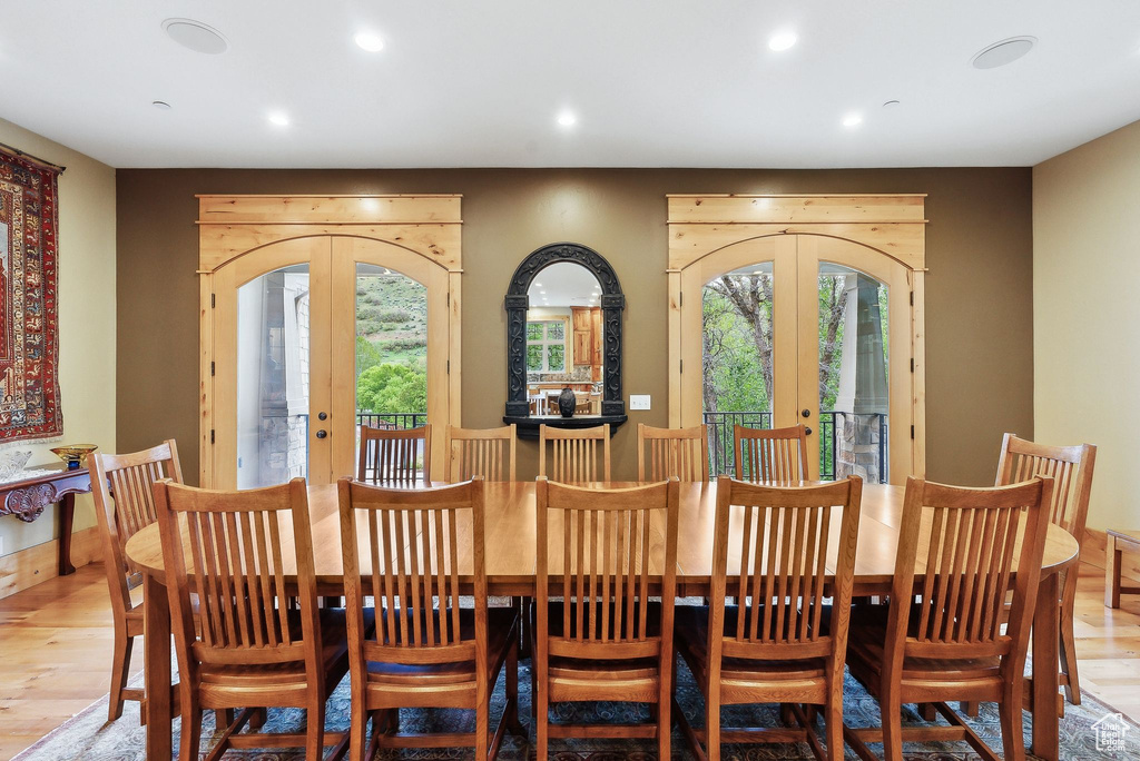 Dining room featuring french doors, plenty of natural light, light wood-style floors, and recessed lighting