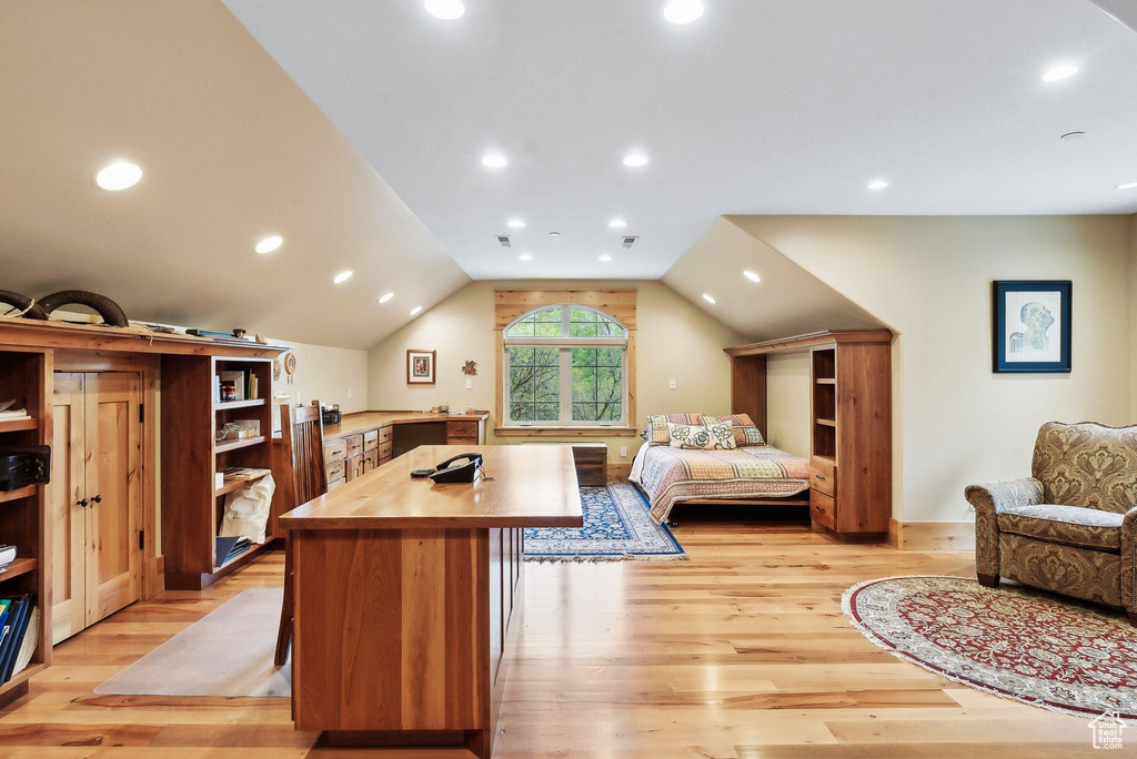 Bedroom with light wood finished floors, vaulted ceiling, and recessed lighting