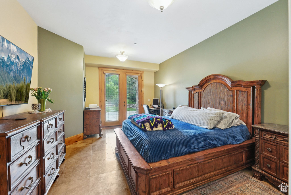 Bedroom with access to exterior, baseboards, and light tile patterned floors