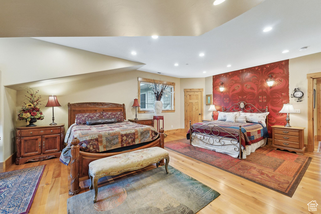 Bedroom with wood finished floors and recessed lighting