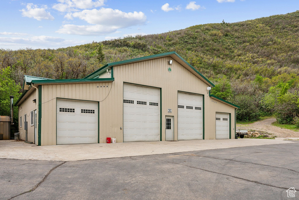 Detached garage featuring a wooded view
