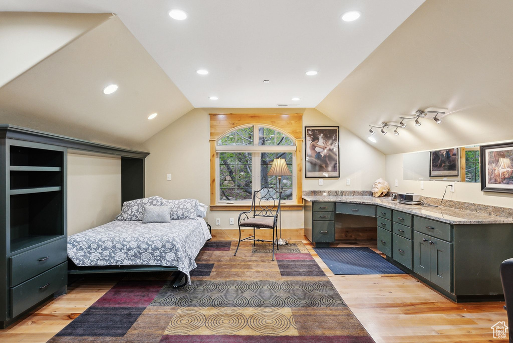 Bedroom featuring light wood finished floors, lofted ceiling, and recessed lighting