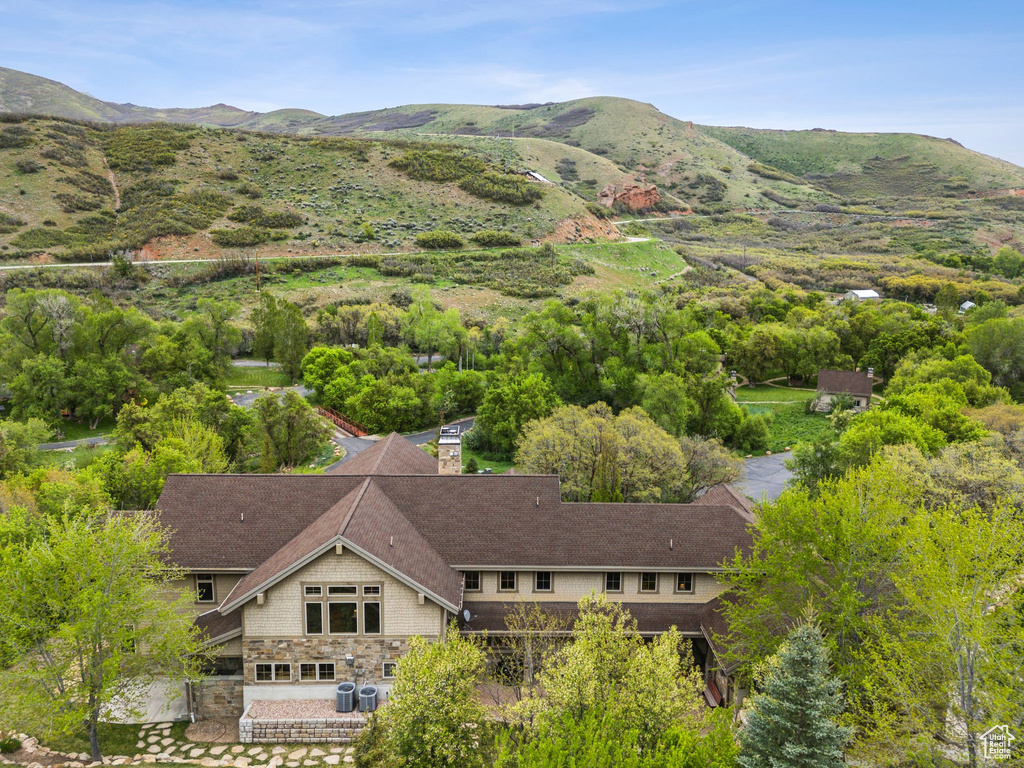 Aerial view of property and surrounding area with a mountainous background