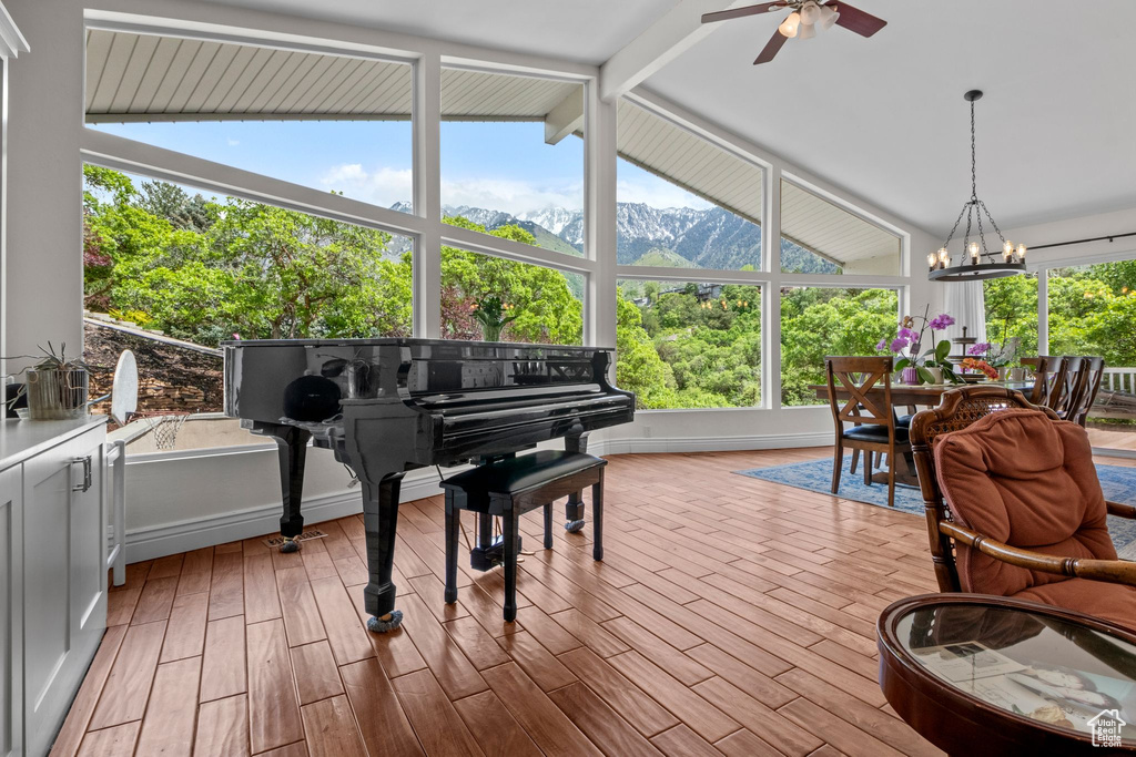 Sunroom featuring a chandelier and a mountain view