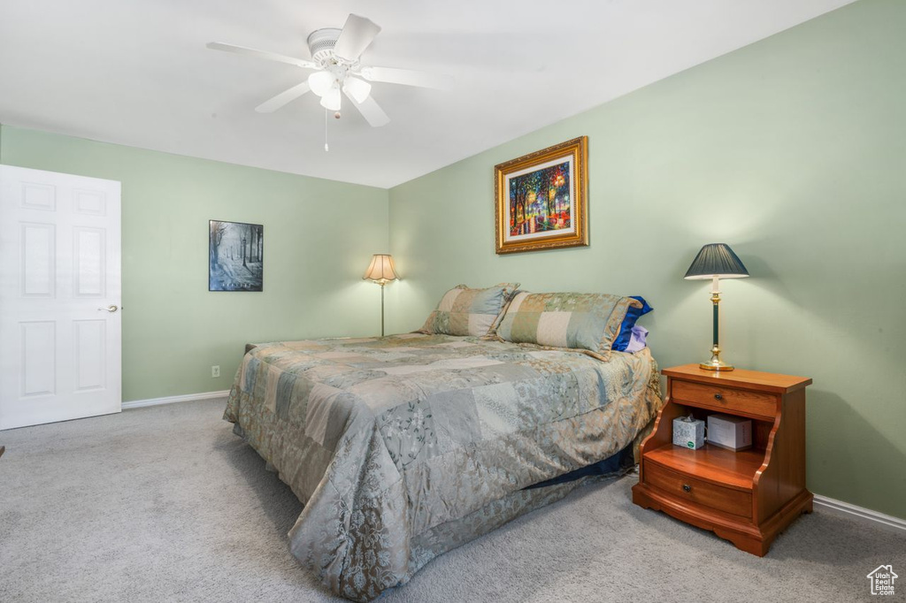 Carpeted bedroom with baseboards and ceiling fan