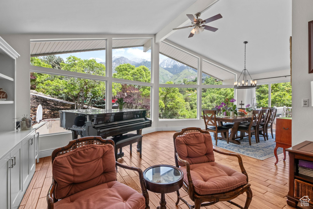 Living area featuring ceiling fan, a chandelier, a mountain view, and light wood-style floors
