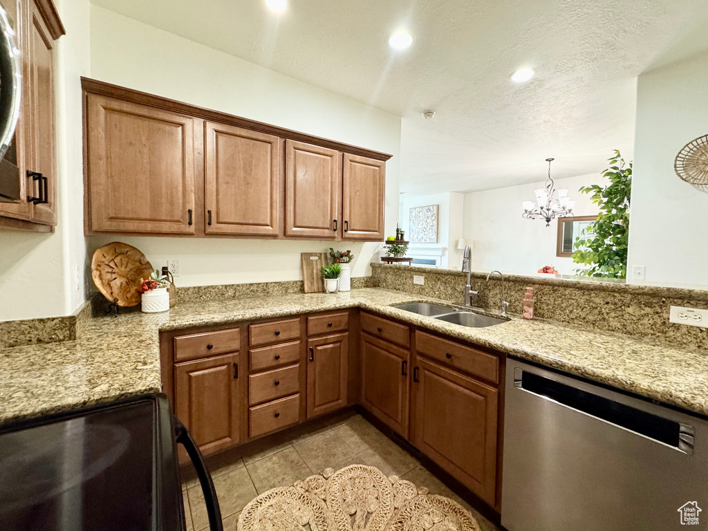 Kitchen featuring dishwasher, a sink, black range with electric stovetop, a chandelier, and recessed lighting