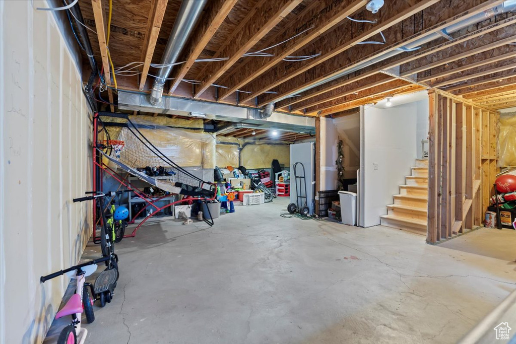 Unfinished below grade area featuring stairs