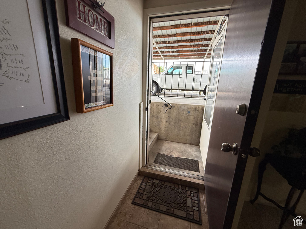 Doorway to outside featuring a textured wall