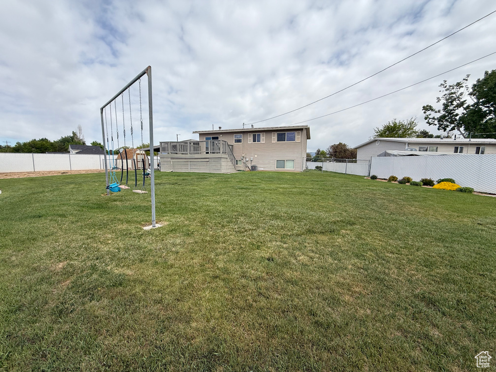 View of yard featuring a deck, a playground, and stairway