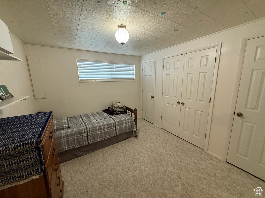 Bedroom featuring light colored carpet