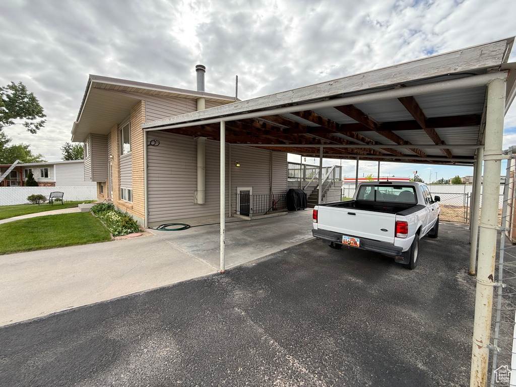 View of car parking featuring asphalt driveway