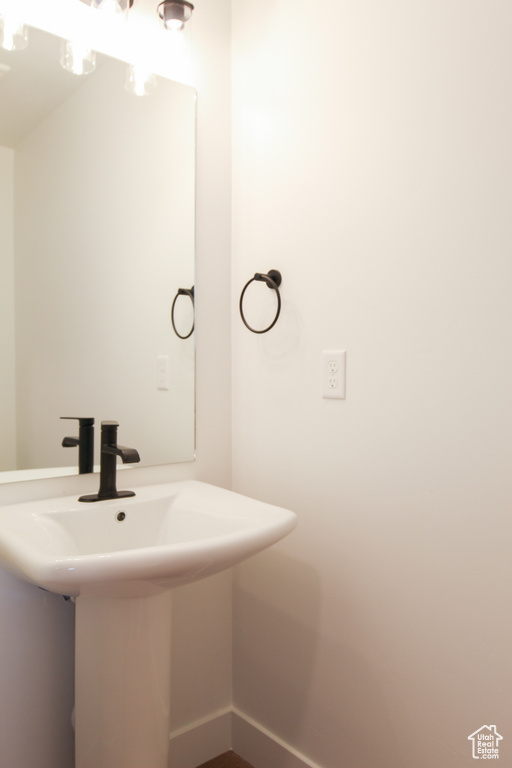 Bathroom with a sink and baseboards