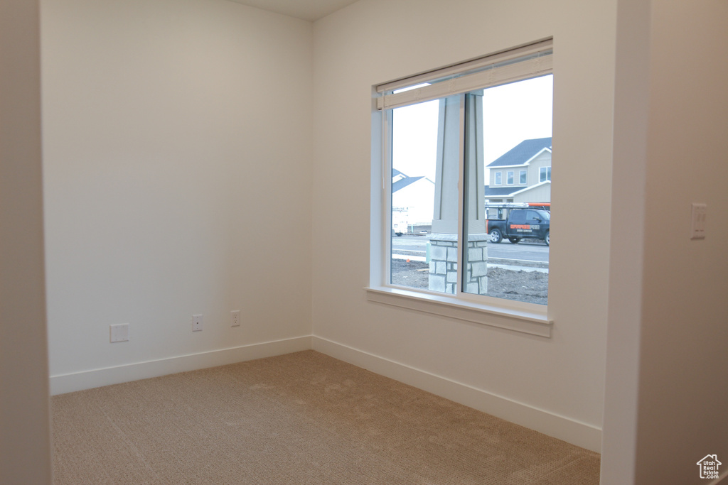 Empty room featuring carpet floors and baseboards
