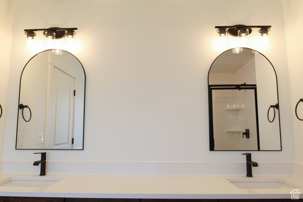 Bathroom featuring vanity and a shower
