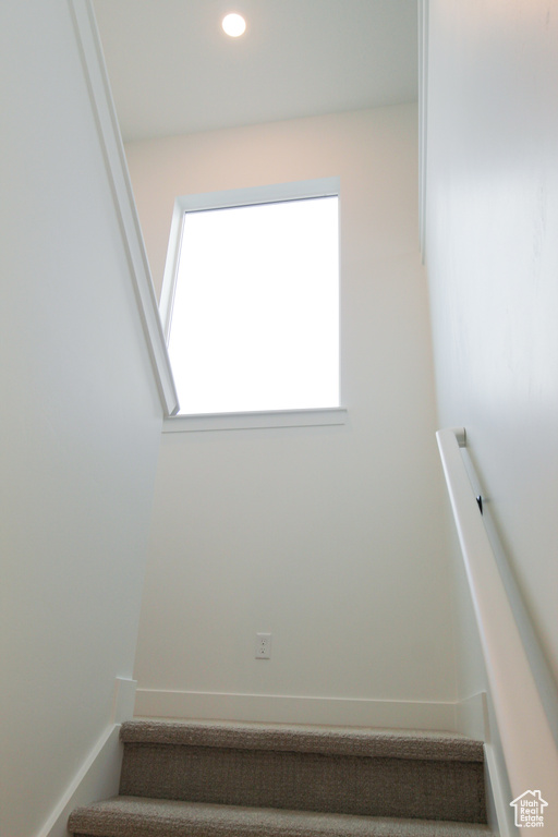 Staircase featuring recessed lighting