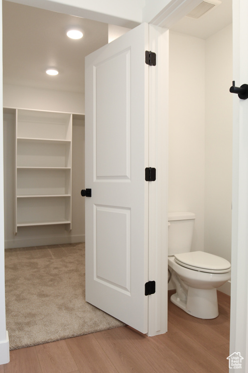 Bathroom featuring wood finished floors and recessed lighting