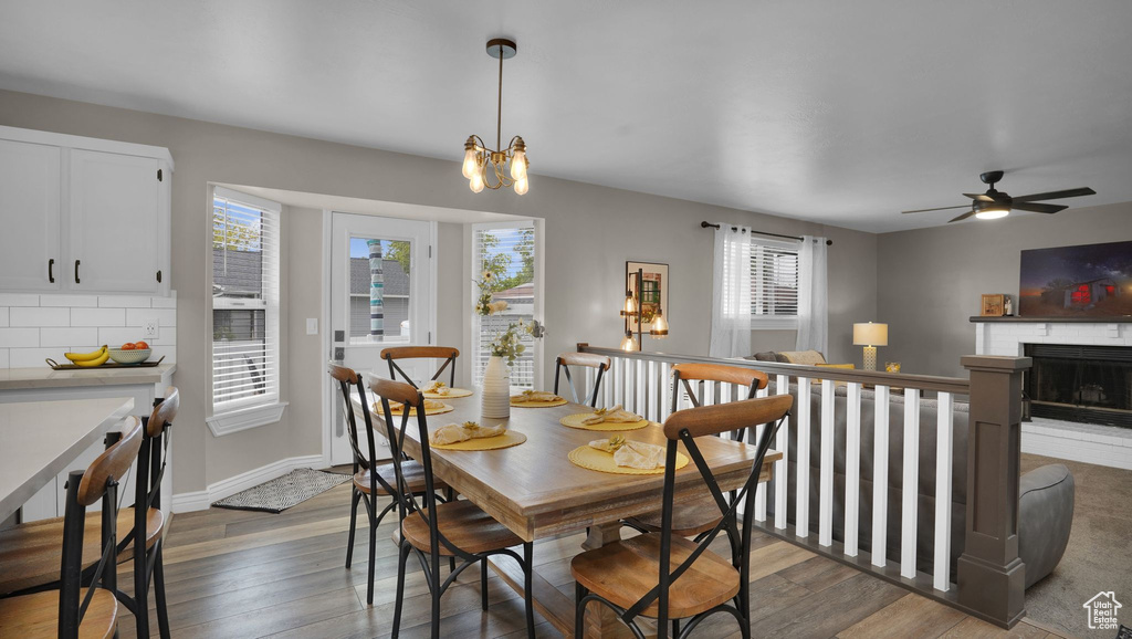 Dining room featuring plenty of natural light, wood finished floors, and a chandelier