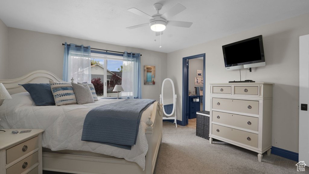 Bedroom featuring light carpet, a ceiling fan, and baseboards