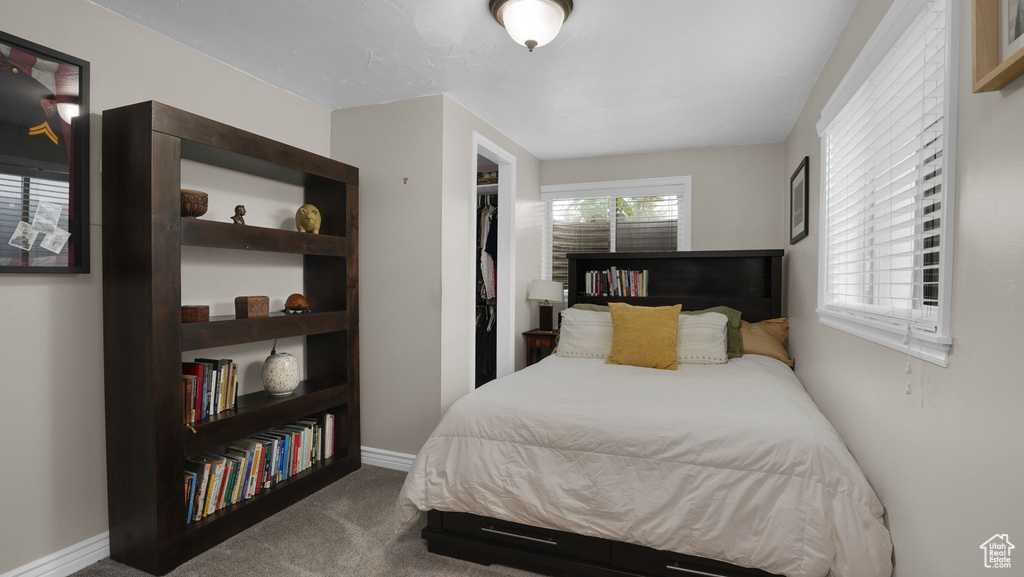 Carpeted bedroom featuring baseboards